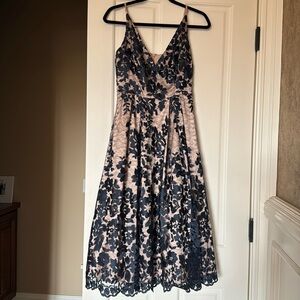 Navy lace and beige. Adjustable straps. Lined.